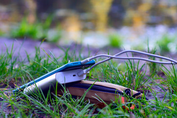Portable charger charges a smartphone in nature. Power Bank on a journey to charge gadgets.