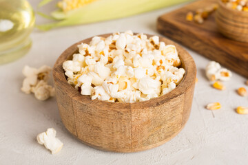 Prepared popcorn with ingredients on wooden table