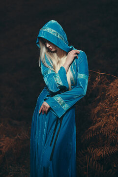 Mysterious woman among autumn ferns