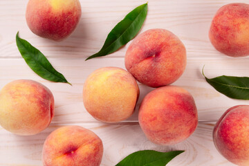 Fresh peaches on a wooden table.