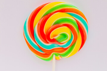 Fototapeta na wymiar round multi-colored candy lollipop close-up on a stick