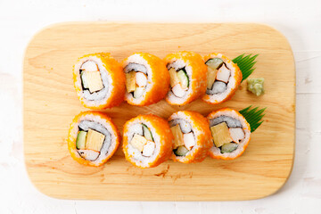 sushi rolls with crab, Japanese omelette and cucumber on a plate.