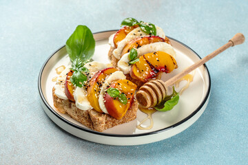 Peach prosciutto bruschetta with mozzarella, basil. Delicious appetizer for wine. Clean eating, dieting, vegan food concept. top view