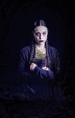 A woman with long braids, with a gothic and dark look, holds an old book in her hands, surrounded by a mysterious and ghostly atmosphere, perfect for Halloween