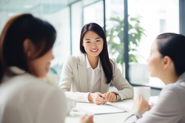 asian business woman having a discussion with her team, co-workers collaborating in a modern office