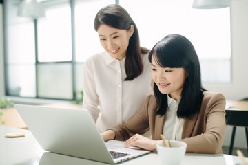 two asian businesspeople working at office