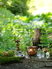 wiccan Goddess ritual figurine with witch cauldron and crystals in forest, abstract natural...