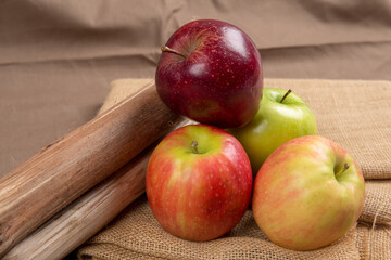 red apple over with leaves on sack background.