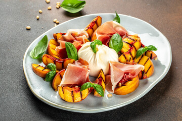 Grilled peach salad with mozzarella, prosciutto ham, basil, olive oil, Restaurant menu, dieting, cookbook recipe top view