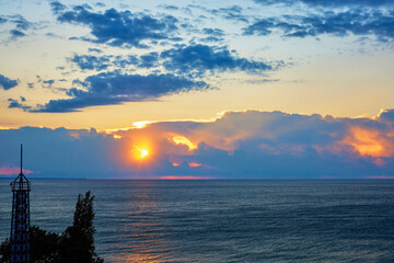 Landscape with the sunrise among the clouds at the sea.