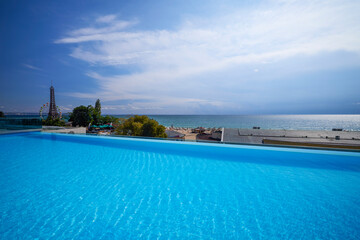 Beautiful landscape with an infinity pool by the sea.