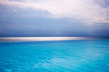 Fototapeta na wymiar Beautiful landscape with an infinity pool by the sea.