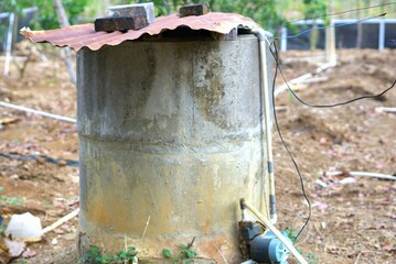 Old well covered with rusty metal, typical Indonesian well