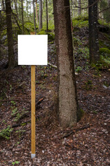 Empty white sign in a forest