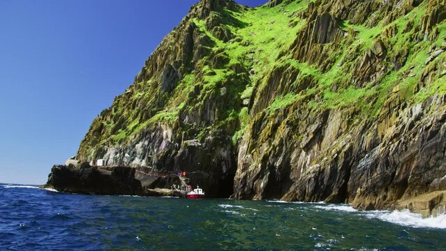 Boat docking on island with rough waters