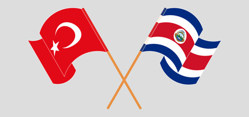 Crossed and waving flags of Turkiye and Costa Rica