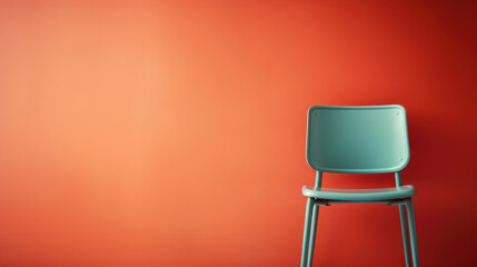 Green chair against the orange wall