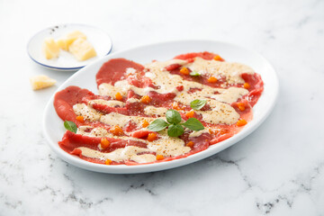 Beef carpaccio with berry sauce