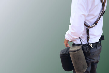 Male officers in white shirts with walkie talkies and tool bags act as event organizers and...