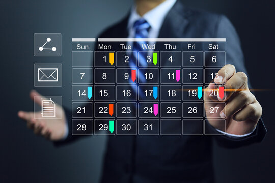 Businessman with calendar meeting schedule marking color note target date appointing reminder appointment calendar for organizer agenda time table and event planner organize and schedule activity.