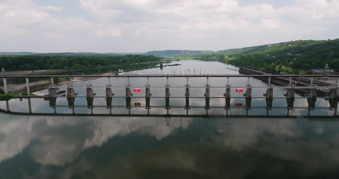 Mirrored Reflections Of Big Dam Bridge (Murray Bridge) On The Waters Of Arkansas River In North Little Rock, Arkansas. aerial sideways