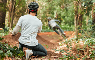 Man, bicycle and forest with photographer, speed and off road for race, cycling video or post on web blog. Guy, bike and recording for vlog, live stream or social network in woods for outdoor sports