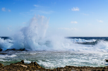 Wild part of the coast with water splashing on rocks, Bonaire, Dutch Caribbean.