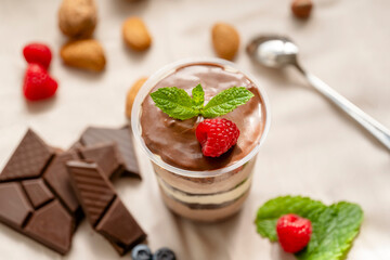 Chocolate Trifle in a cup with pieces of chocolate, strawberries, hazelnuts