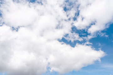 white cirrus, feathery clouds against spring bright blue cloudy sky on sunny day in England