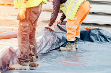 Ground floor waterproofing membrane installation on new house