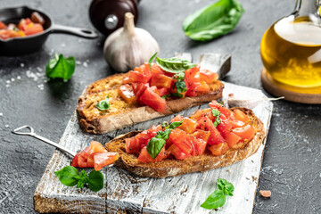 tomato bruschetta on a wooden board, Italian appetizers, Food recipe background. Close up