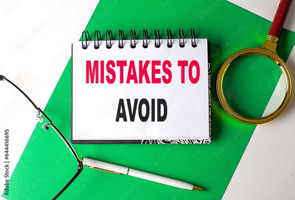 Aufkleber mistakes to avoid text on notebook on green paper