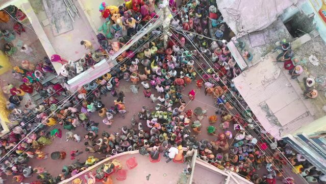 Barsana, India - 28 February 2023: Aerial view of people celebrating the holy colour festival in the street in Barsana, Uttar Pradesh, India.