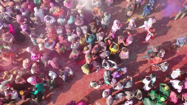 Barsana, India - 28 February 2023: Aerial view of people celebrating the holy colour festival in the street in Barsana, Uttar Pradesh, India.