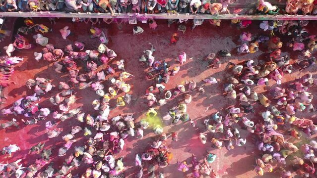 Barsana, India - 28 February 2023: Aerial view of people celebrating the holy colour festival in the street in Barsana, Uttar Pradesh, India.
