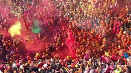 Barsana, India - 28 February 2023: Aerial view of people celebrating the holy colour festival in the street in Barsana, Uttar Pradesh, India.