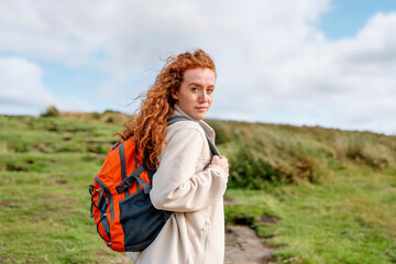 amazed Woman in jacket reaching the destination and taking selfie and shouting on the top of mountain at sunset. Travel Lifestyle concept The national park Peak District in England