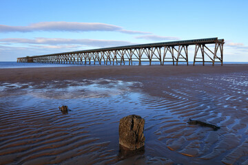 View of a old derelict industrial pier with groins in the foreground. Hartlepool, County Durham,...