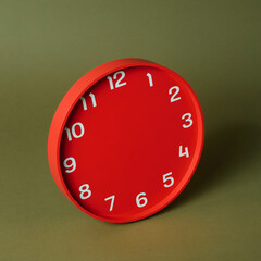 red clock without hands on a green background
