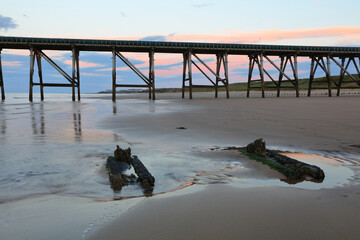 View of a old derelict industrial pier with groins in the foreground. Hartlepool, County Durham,...