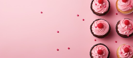 Raspberry filled cupcakes with a polka dot design isolated pastel background Copy space - obrazy, fototapety, plakaty