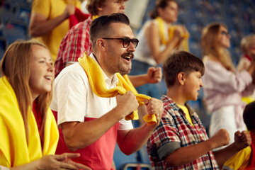 Young emotional people, sport fans attending live football match to cheer up favourite team. Sport enthusiasts. Concept of sport, cup, world, team, event, competition, emotions, championship, betting