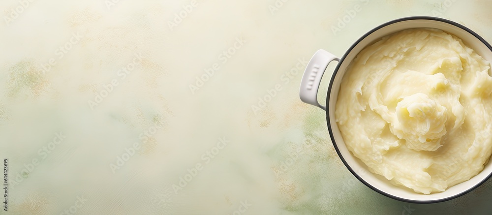 Poster potatoes mashed in large pot with spoon isolated pastel background copy space