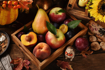 Top view of autumn fruits in in the box on wooden table