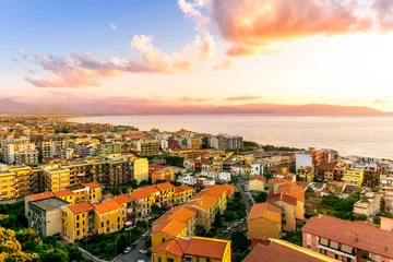 Poster panoramic summer travel view from a hill to  beautiful sea coast historical town with port, amazing ocean bay and gulf and beautiful mountains with scenic sunset on background. © Yaroslav