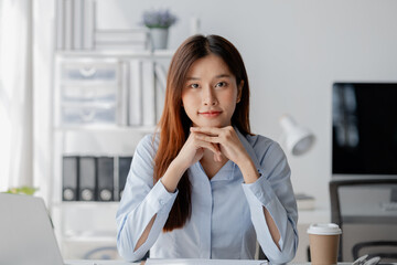 Asian woman sitting in startup company office, marketing analyzing and planning marketing for company growth, sales management. Businessman concept, marketing planning.