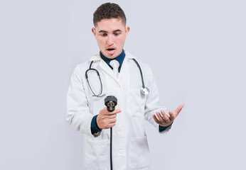 Amazed young doctor with blood pressure monitor isolated. Surprised doctor looking at tensiometer on white background