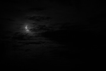 A narrow semicircle of solar disk during eclipse in cloudy cloudy weather, Earth does not completely cover the sun.