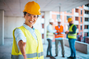 A female architect is standing and shaking hands. Copy space for your text. Architect giving hand for a handshake. Female Architect extending hand to shake. 