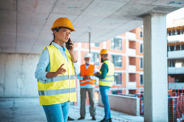 Construction woman closing deal on the phone. Portrait of civil engineer woman doing business,...